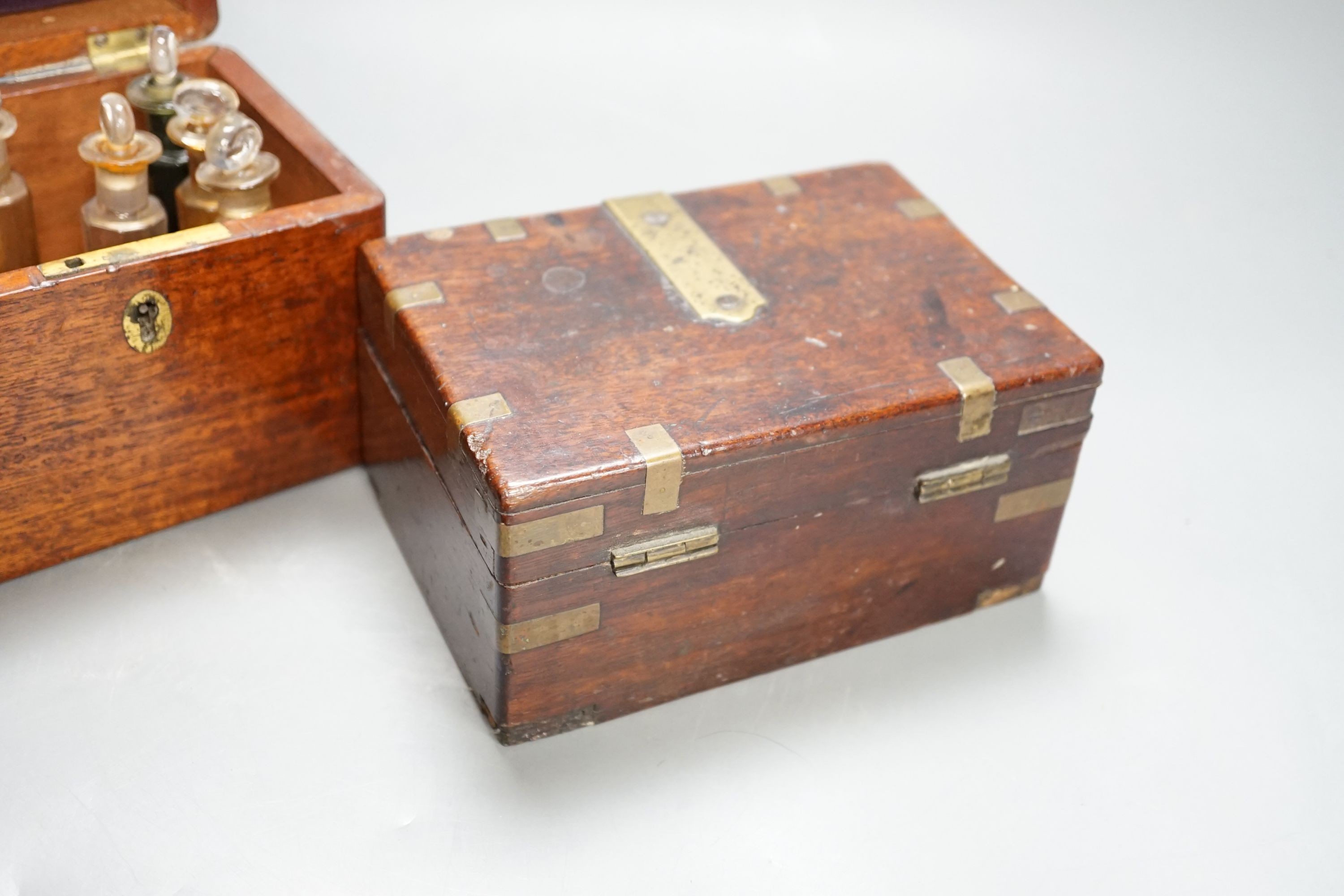 A Victorian mahogany medicine case, with bottles, 13cm. wide, a brass-mounted box and a rosewood veneered pen box